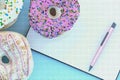 Colorful donut graphic pixel with clipboard on blue