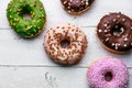 Colorful donuts close up on white background