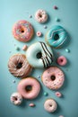 Colorful donuts with sprinkles on blue background, top view