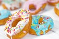 Colorful Donuts turquoise and pink on White Background close-up. Doughnuts with multi colored glaze. Doughnuts are traditional