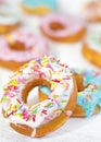 Colorful Donuts turquoise and pink on White Background close-up. Doughnuts with multi colored glaze. Doughnuts are traditional