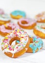 Colorful Donuts turquoise and pink on White Background close-up. Doughnuts with multi colored glaze. Doughnuts are traditional