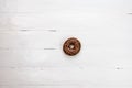 Colorful donuts on white wooden table. Sweet icing sugar food with glazed sprinkles, doughnut with frosting. Top view with copy Royalty Free Stock Photo