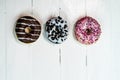 Colorful donuts on white wooden table. Sweet icing sugar food with glazed sprinkles  doughnut with frosting. Top view with copy Royalty Free Stock Photo