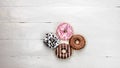 Colorful donuts on white wooden table. Sweet icing sugar food with glazed sprinkles, doughnut with frosting. Top view with copy Royalty Free Stock Photo