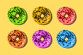 Colorful donuts on a yellow background. Minimum summer concept. Flat layout, top view