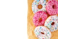 Colorful donuts on yellow paper bag on isolated white background Royalty Free Stock Photo