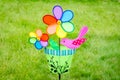 Colorful double pinwheel with bird on green grass Royalty Free Stock Photo