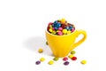 Colorful dragees in yellow cup