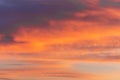 Colorful dramatic sky at sunset with layered rain clouds of purple and gold color Royalty Free Stock Photo