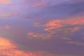 Colorful dramatic sky at sunset with layered rain clouds of purple and gold color Royalty Free Stock Photo