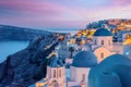 Colorful and Dramatic Sunset with Night Lights in Mediterranean Town of Oia, Santorini, Greece, Europe Royalty Free Stock Photo