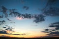 Colorful dramatic sunset on sky with bizarre clouds Royalty Free Stock Photo