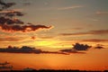 Colorful dramatic sunset on sky with bizarre clouds Royalty Free Stock Photo