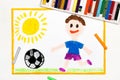 drawing: smiling boy playing football