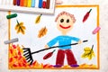 drawing: A smiling boy is raking leaves Royalty Free Stock Photo