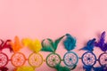 Colorful dreamcatcher on pink background.