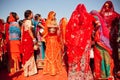 Colorful dressed young women in crowd of indian ladies