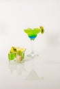 Colorful drink in a margarita glass, blue and green combination, many drinks in a shotglass Royalty Free Stock Photo