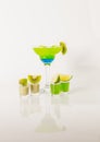 Colorful drink in a margarita glass, blue and green combination, many drinks in a shotglass Royalty Free Stock Photo