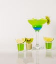 Colorful drink in a margarita glass, blue and green combination, many drinks in a shotglass Royalty Free Stock Photo