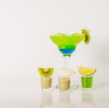 Colorful drink in a margarita glass, blue and green combination, many drinks in a shotglass Royalty Free Stock Photo