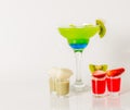 Colorful drink in a margarita glass, blue and green combination, many drinks in a shotglass Royalty Free Stock Photo