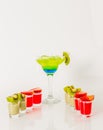 Colorful drink in a margarita glass, blue and green combination, many drinks in a shotglass Royalty Free Stock Photo