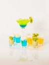 Colorful drink in a margarita glass, blue and green combination, many drinks in a shotglass Royalty Free Stock Photo