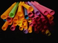 Colorful drinking straw in black background many colors Royalty Free Stock Photo