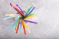 Colorful drinking straw in glass on grey background, top view. Royalty Free Stock Photo