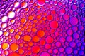 Colorful drops of oil on the water. Blue, red and purple colored circles and ovals. Abstract background for design Royalty Free Stock Photo