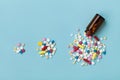 Colorful Drug Pills On Blue Background, Increasing Use And Abuse Of Medication In World Concept