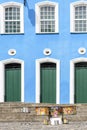 Colorful drums in front of colonial style facade and stairs