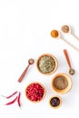 Colorful dry herbs and spices for cooking food white kitchen table background top view space for text Royalty Free Stock Photo