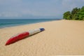 Colorful dugout fishing boat laying on deserted tropical beach at Robertsport, Liberia, West Africa Royalty Free Stock Photo