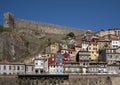 Colorful dwellings and a medieval wall along the Douro River in the Ribeira neighborhood of Porto, Portugal.