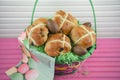 Chocolate Easter eggs and food in a gift basket with pink table background