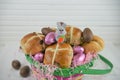 Cute Easter basket gift filled with chocolate eggs and Easter bunny decoration Royalty Free Stock Photo