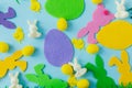 Colorful Easter bunnies, eggs, chicks composition on blue background flat lay. Happy Easter! Purple, pink, yellow artificial bunny Royalty Free Stock Photo