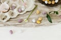 Colorful easter chocolate eggs, spring flowers and linen cloth on rustic wooden table. Space for text. Easter modern simple Royalty Free Stock Photo