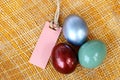 Colorful easter egg on bamboo weave background with paper tag Royalty Free Stock Photo