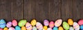 Colorful Easter Egg bottom border over a dark wood banner background Royalty Free Stock Photo