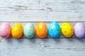 Easter composition of bright Easter eggs on a light wooden background Royalty Free Stock Photo
