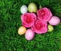 Colorful Easter Egg and Pink Roses on Green Grass