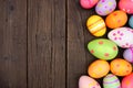 Colorful Easter Egg side border over a dark wood background Royalty Free Stock Photo