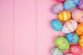 Colorful Easter Egg side border over a pink wood background Royalty Free Stock Photo