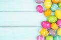 Colorful Easter Egg side border over a soft blue wood background Royalty Free Stock Photo