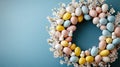 Colorful easter egg wreath with blossoms and small birds on blue background Royalty Free Stock Photo