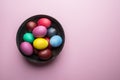 Colorful Easter eggs as an attribute of Easter celebration on the plate. Top view